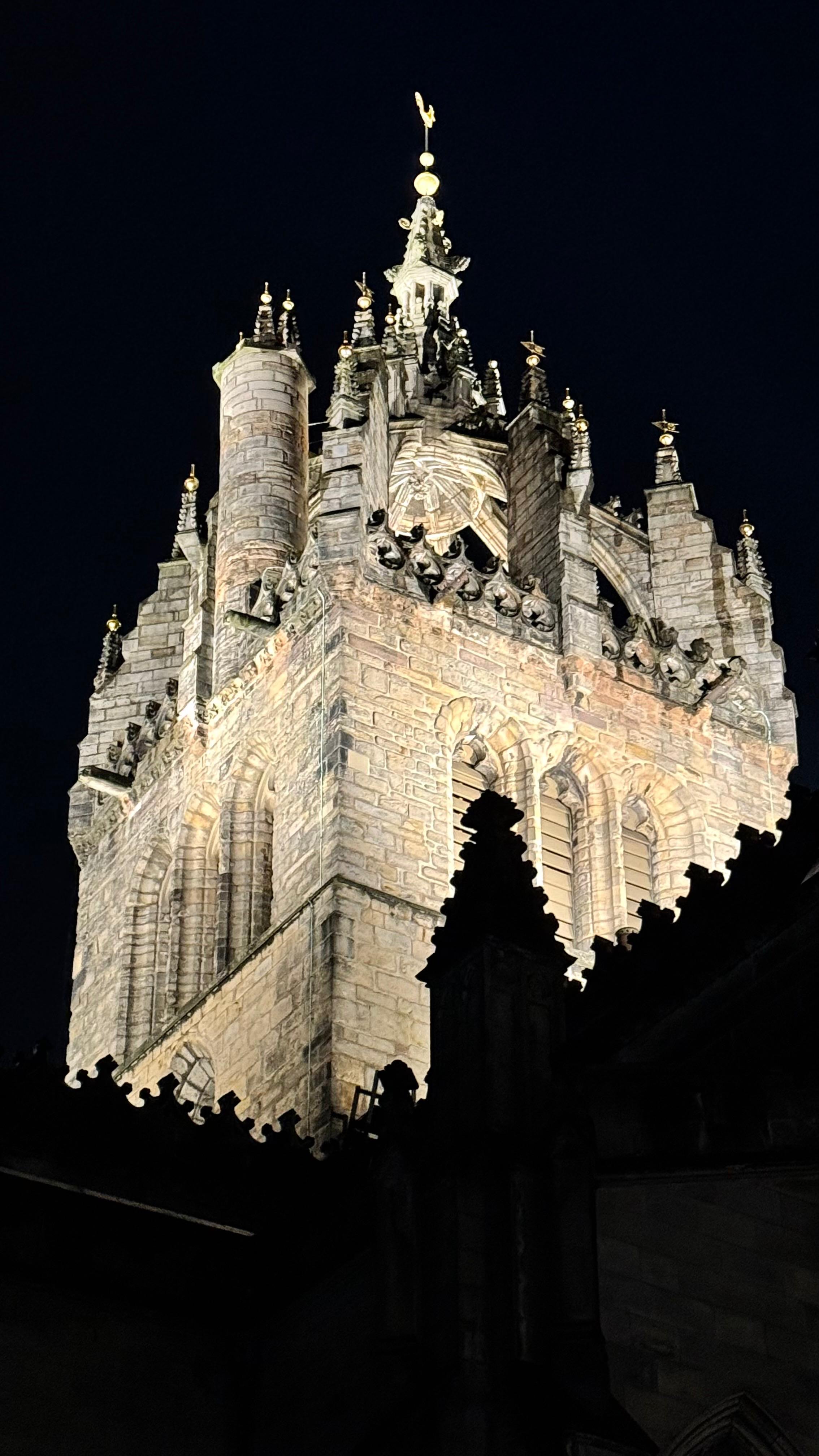 St Giles Cathedral Edinburgh illuminated at night, golden stone against black sky